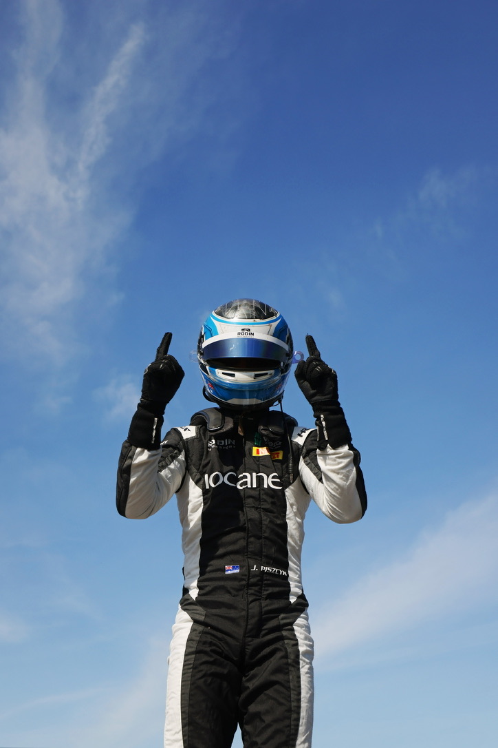 Jimmy Piszcyk in his race suit and helmet on the grid
